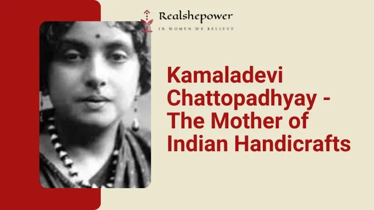 An Older Black-And-White Photograph Of Kamaladevi Chattopadhyay, A Woman With Short Hair And Wearing A Saree, Seated With Her Hands Clasped Together And Looking Directly At The Camera. She Is Known As The Mother Of Indian Handicrafts.