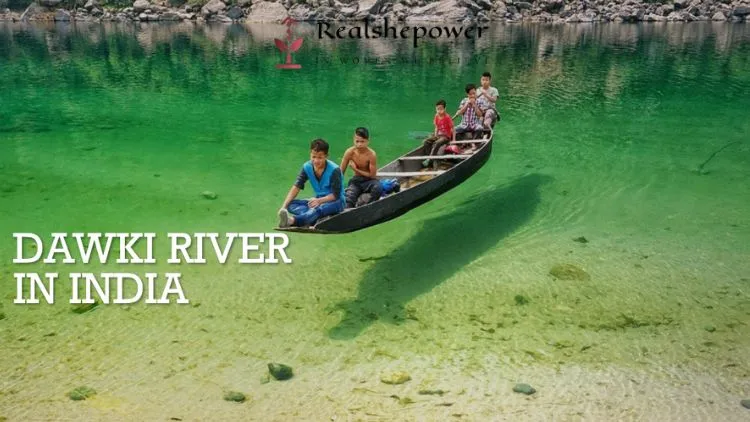 Image Of Crystal Clear Dawki River In India Showcasing Its Mesmerizing Natural Beauty With A Boat Carrying 4 People.